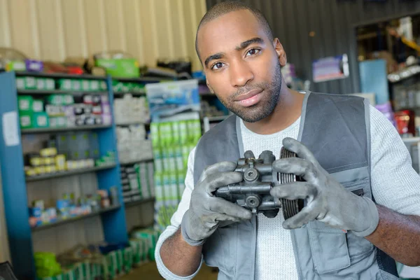 Portrait of man holding second hand automobile part — Stock Photo, Image