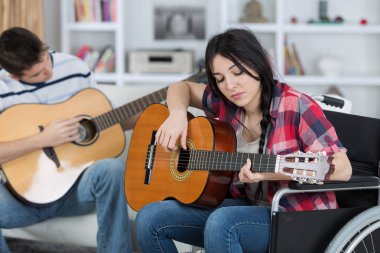 disabled girl playing guitar with a friend clipart