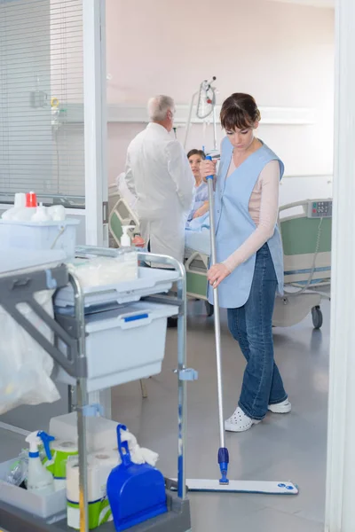 Cleaner sweeping floor in hospital — Stock Photo, Image