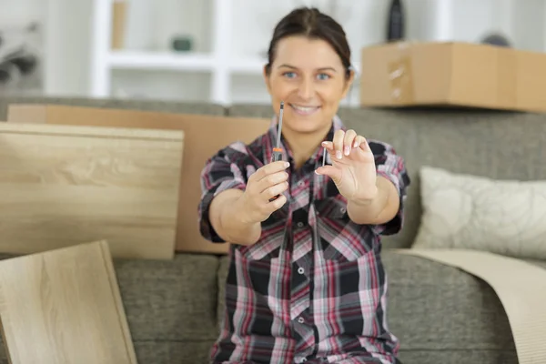 Woman with self assembly furniture in kitchen — Stock Photo, Image
