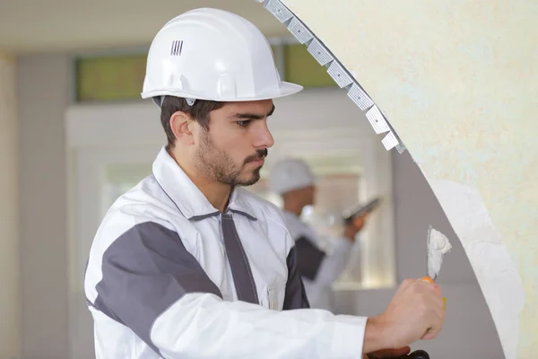 Young plasterer working on indoor wall — Stock Photo, Image