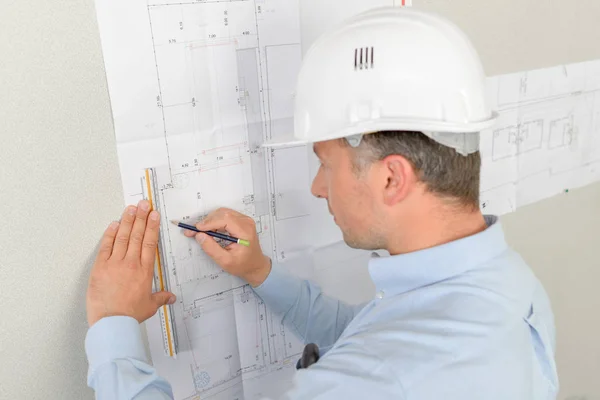 Architect writing on his blue prints — Stock Photo, Image