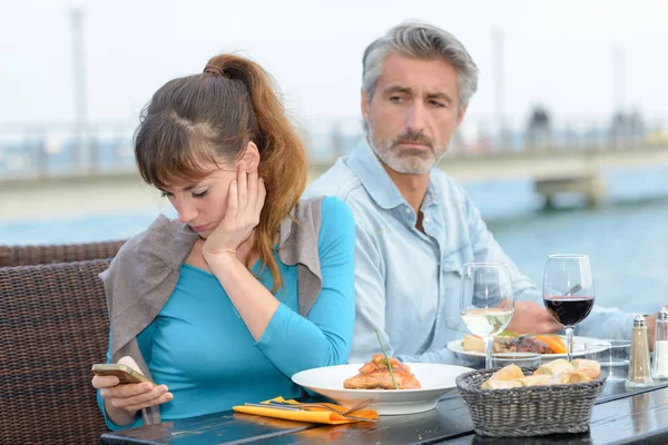 Mulher desconsiderando o parceiro durante a refeição — Fotografia de Stock