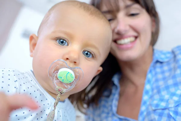 Retrato de um lindo bebê com uma jovem mãe — Fotografia de Stock