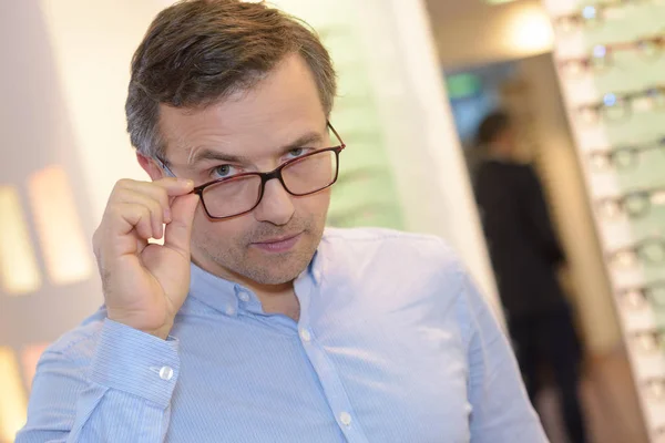 Man looking over the top of spectacles — Stock Photo, Image