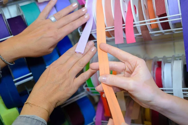 Women comparing strips of ribbon — Stock Photo, Image