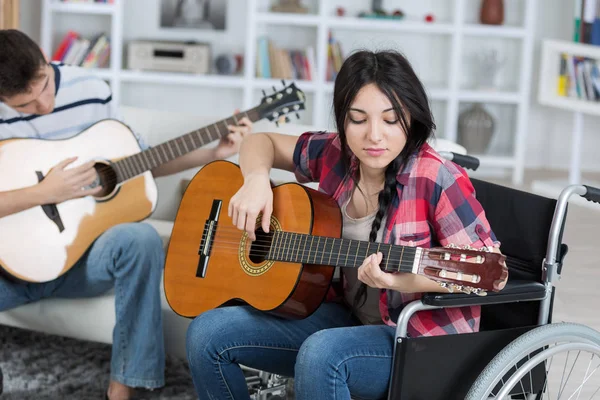 Młodych niepełnosprawnych dziewczyna gra na gitarze — Zdjęcie stockowe