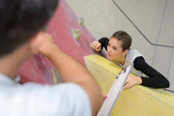 Fit couple rock climbing indoors at the gym — Stock Photo, Image
