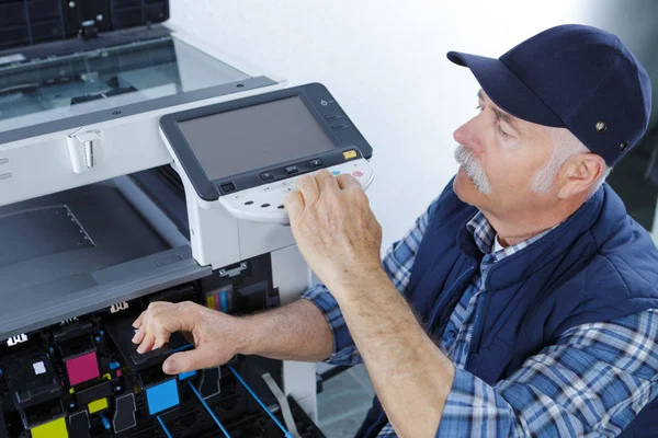Técnico masculino reparando máquina fotocopiadora digital — Fotografia de Stock