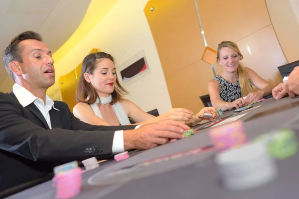 People around casino table — Stock Photo, Image