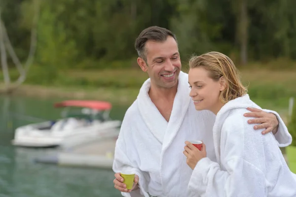 Romantic couple sitting on the pier — Stock Photo, Image