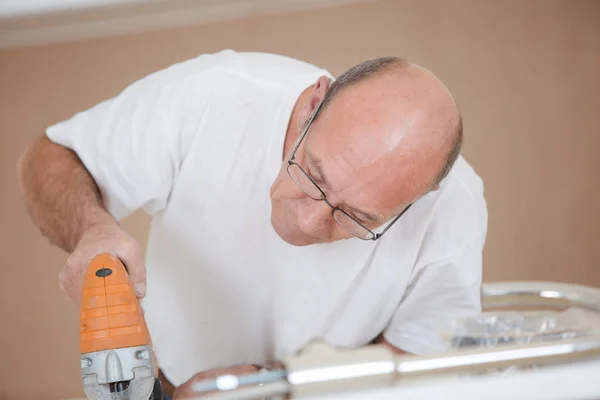 Man works with a saw — Stock Photo, Image