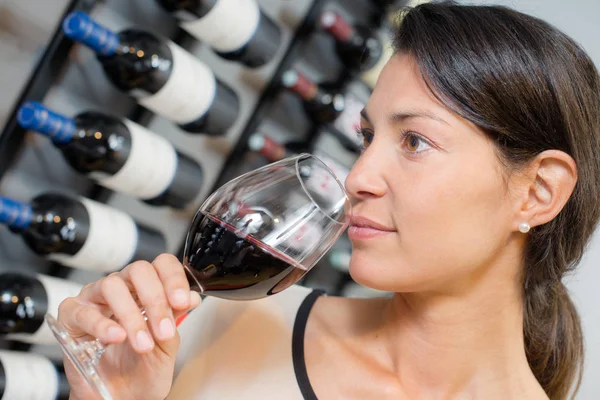 Woman smelling wine and adult — Stock Photo, Image