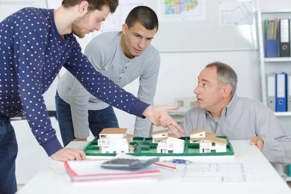 Three architects discussing reproduction of a development — Stock Photo, Image