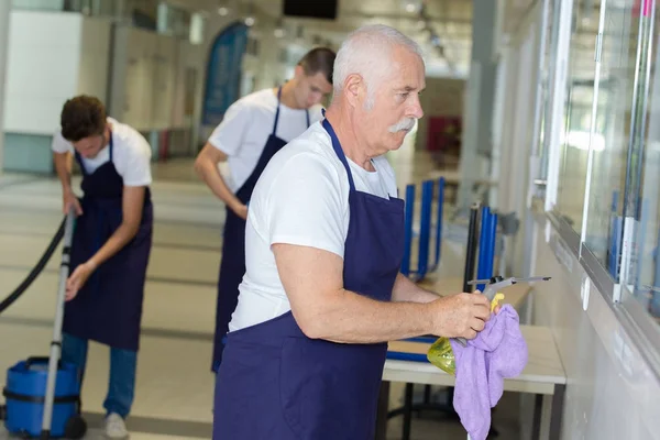 Happy cleaners team at work — Stock Photo, Image