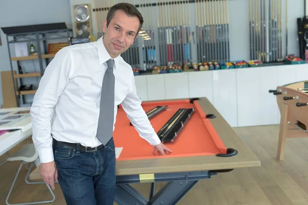 Playing billiards at red pool table — Stock Photo, Image