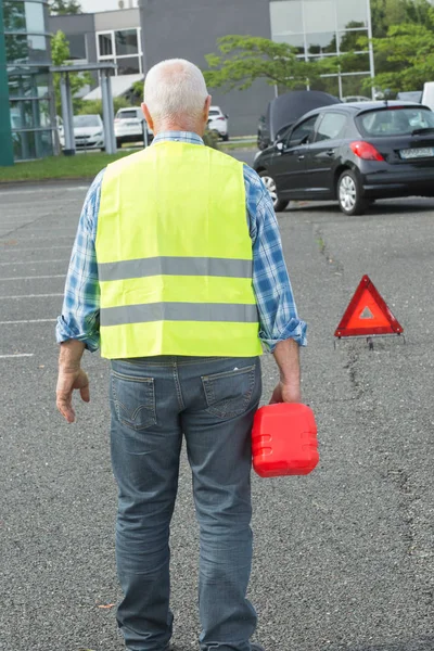 Senior aged man holding gas can to refill his car — Stock Photo, Image