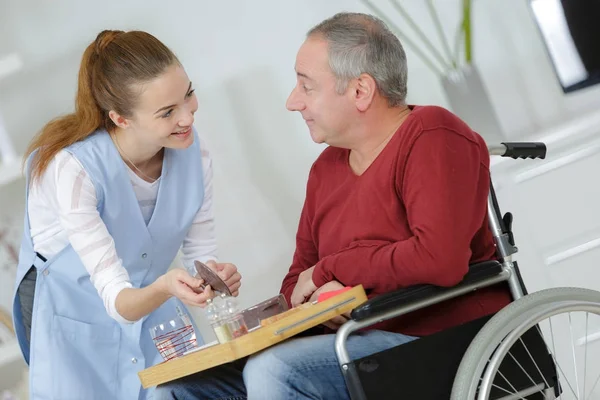 Фото счастливого пожилого человека с инвалидностью и полезной медсестрой — стоковое фото