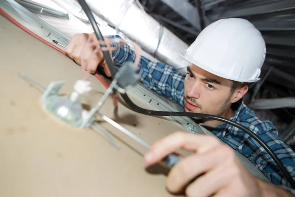 Electrician installing hanging lights — Stock Photo, Image