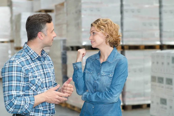 Mulher e homem durante a gestão invertory armazém — Fotografia de Stock