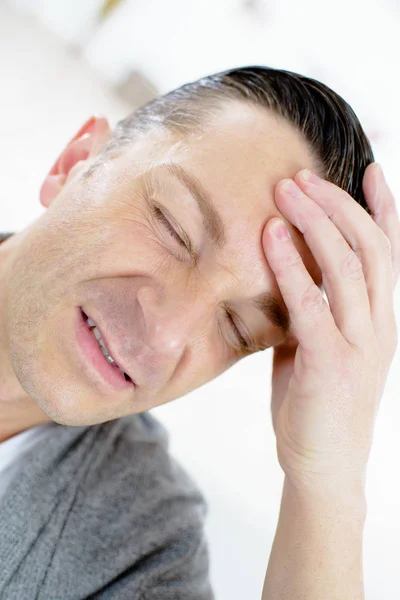 Young man with a headache — Stock Photo, Image