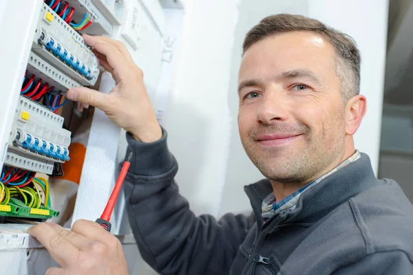 Tecnico maschio esaminando fusebox — Foto Stock