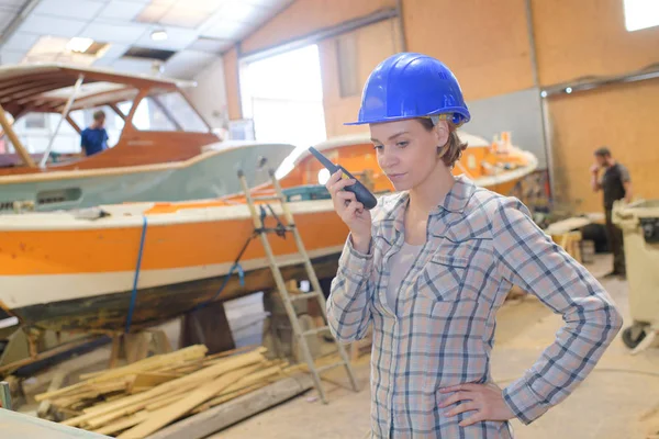 Mulher com um walkie-talkie e um capacete — Fotografia de Stock