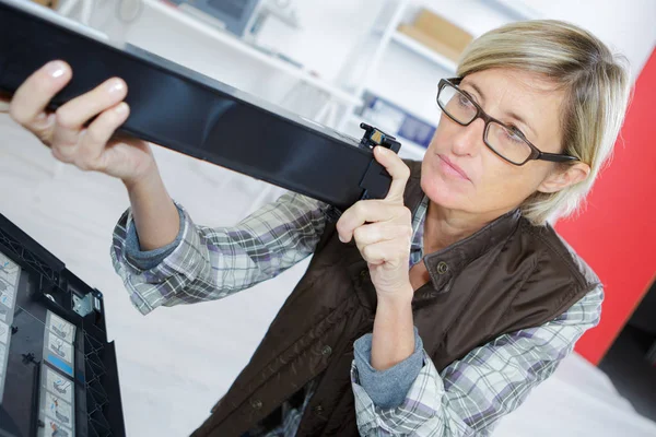 Frau führt Tonerwechsel und Druckerwartung durch — Stockfoto