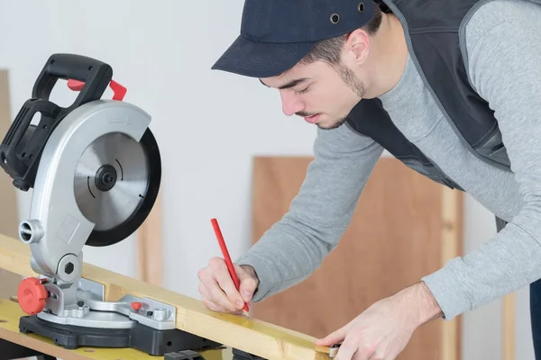Worker marking wood and pencil — Stock Photo, Image