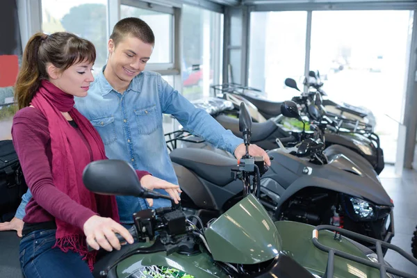Young couple looking at quad bikes — Stock Photo, Image
