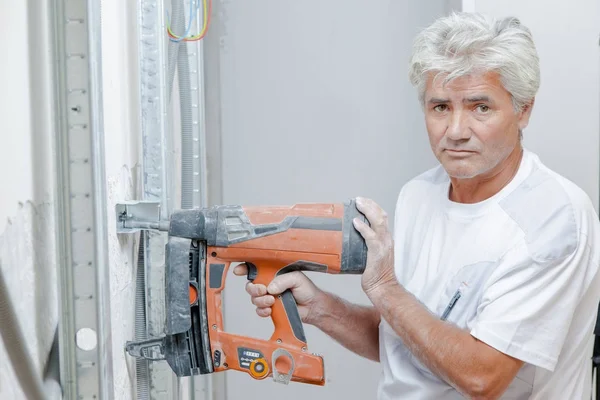 Mason using a nail gun — Stock Photo, Image