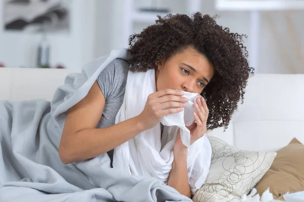 Erkältete Frau liegt mit Gewebe im Bett — Stockfoto