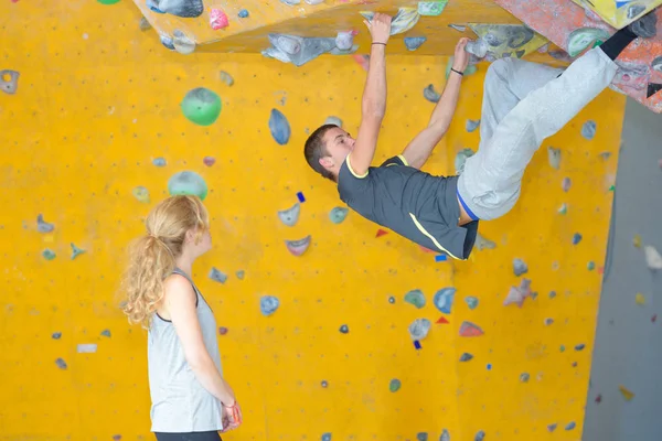 Man on angled climbing wall