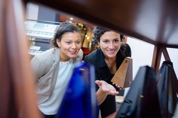 Giovane cliente femminile con assistente in una boutique — Foto Stock