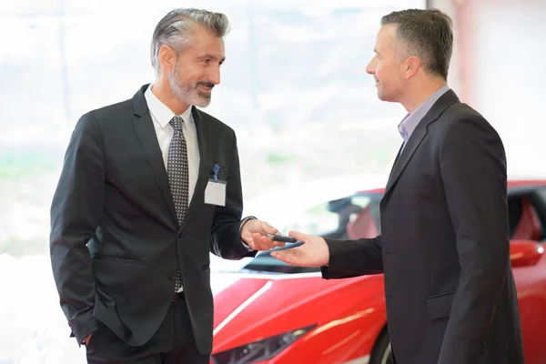 Car dealer showing auto garage — Stock Photo, Image