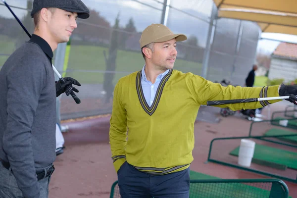 Due golfisti maschi che guardano avanti — Foto Stock