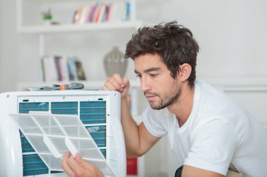 Man assembling air conditioning unit clipart