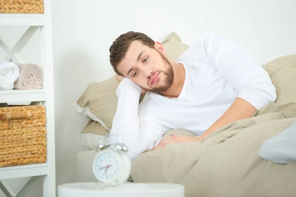 man having trouble waking up in the morning