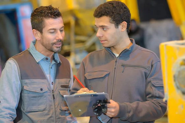 Boss and worker together in a carpenters workshop — Stock Photo, Image