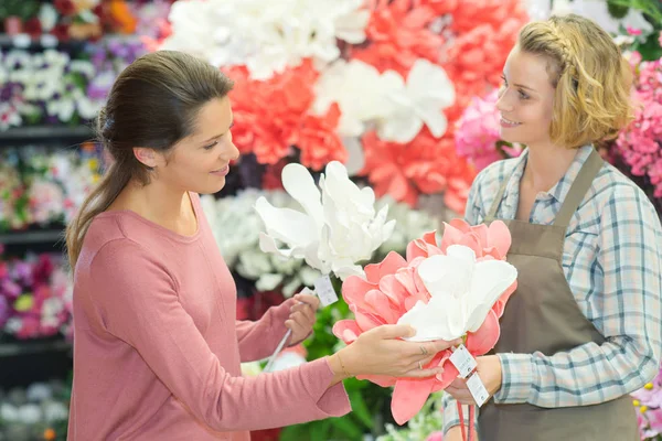 Приваблива молода дівчина працює в квітковому магазині — стокове фото