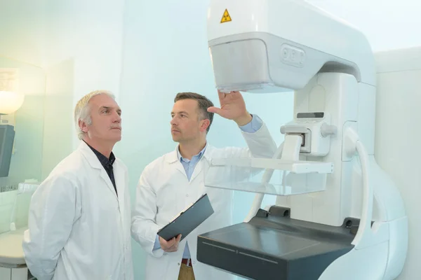 doctors next to an ultrasound machine