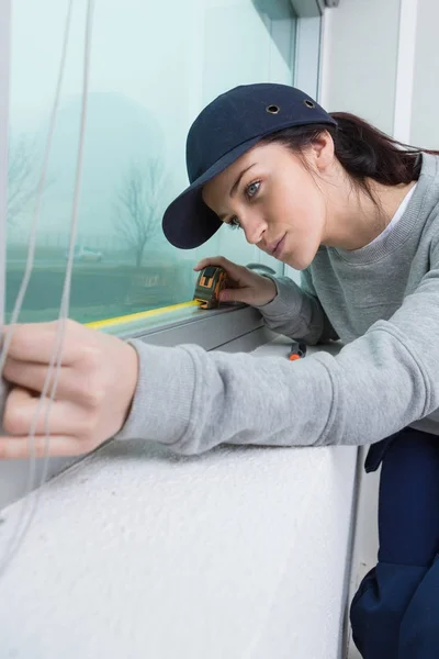 Woman measuring window and measure — Stock Photo, Image
