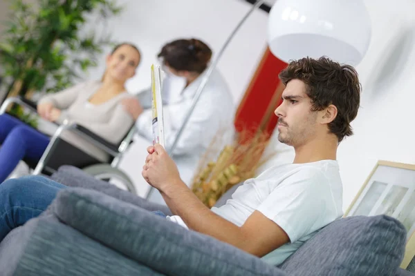 Different people sitting in a waiting room of a hospital — Stock Photo, Image