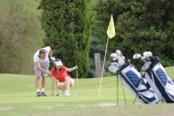 Pareja jugando golf y pareja —  Fotos de Stock