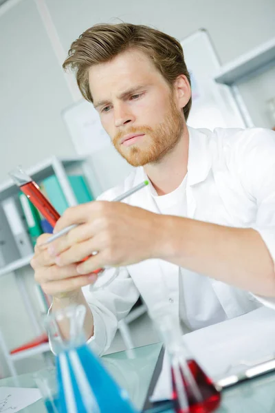 Hombre científico sosteniendo tubo de ensayo con muestra de sangre —  Fotos de Stock