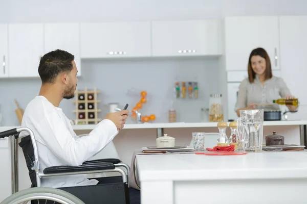 Couple cooking together - man disabled on wheelchair — Stock Photo, Image