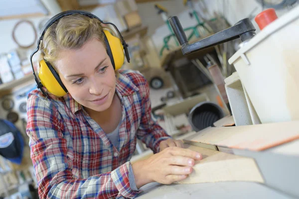 Fiatal női carpenter, biztonsági berendezések favágás — Stock Fotó