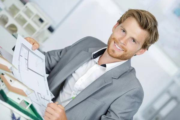 Happy smiling engineer working on plane of house — Stock Photo, Image