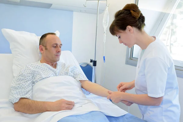 Sjuksköterskan tittar efter patienten — Stockfoto