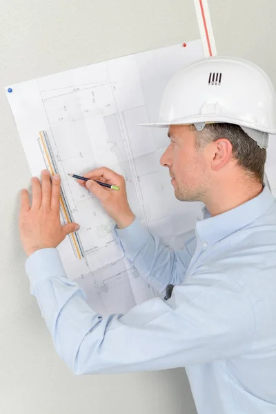 Architect writing on blueprints — Stock Photo, Image